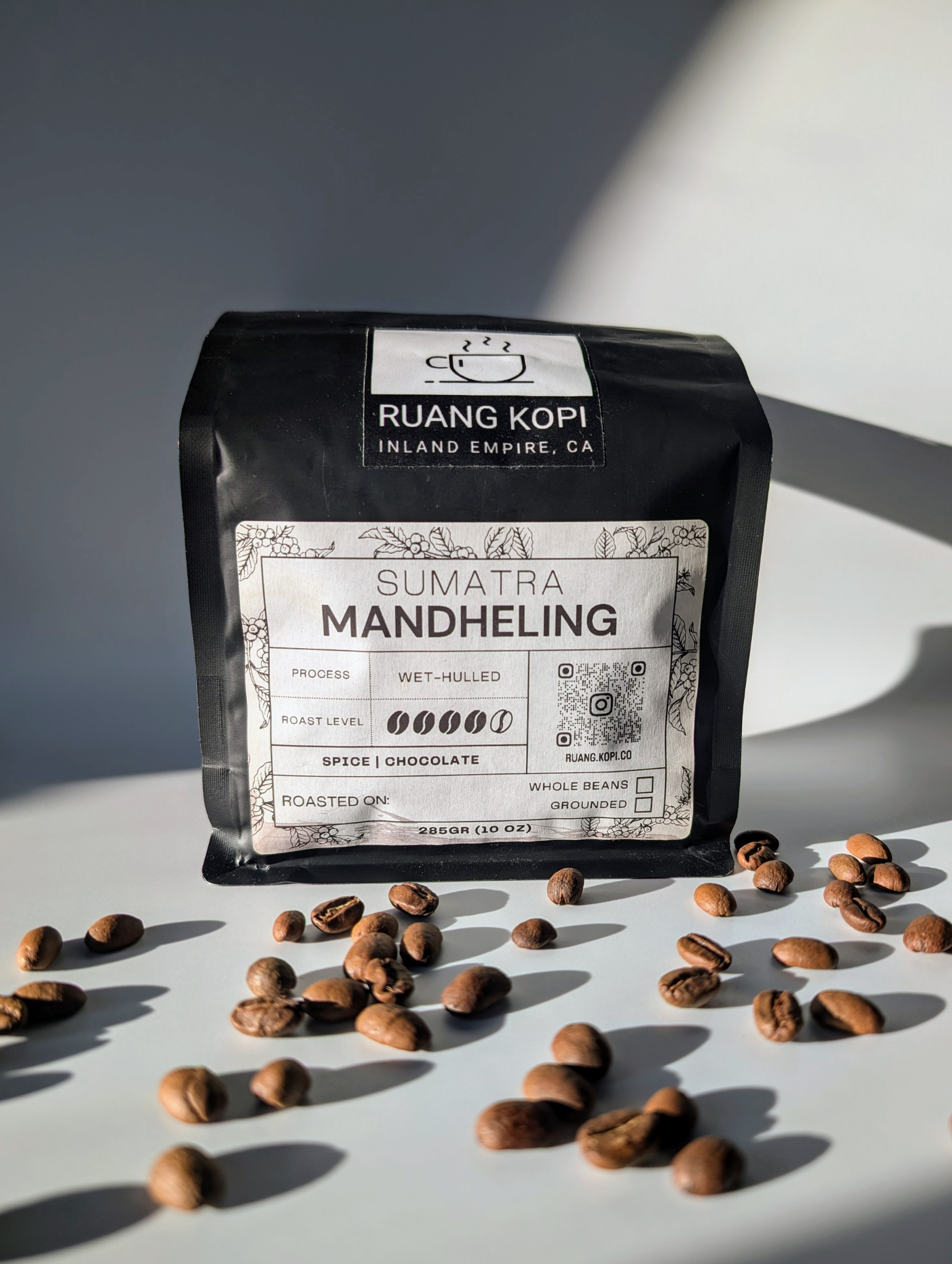 Sumatra Mandheling roasted coffee bag from Ruang Kopi Roastery, showcasing specialty single origin premium coffee in a visually appealing studio product photo with golden hour lighting on a white background.